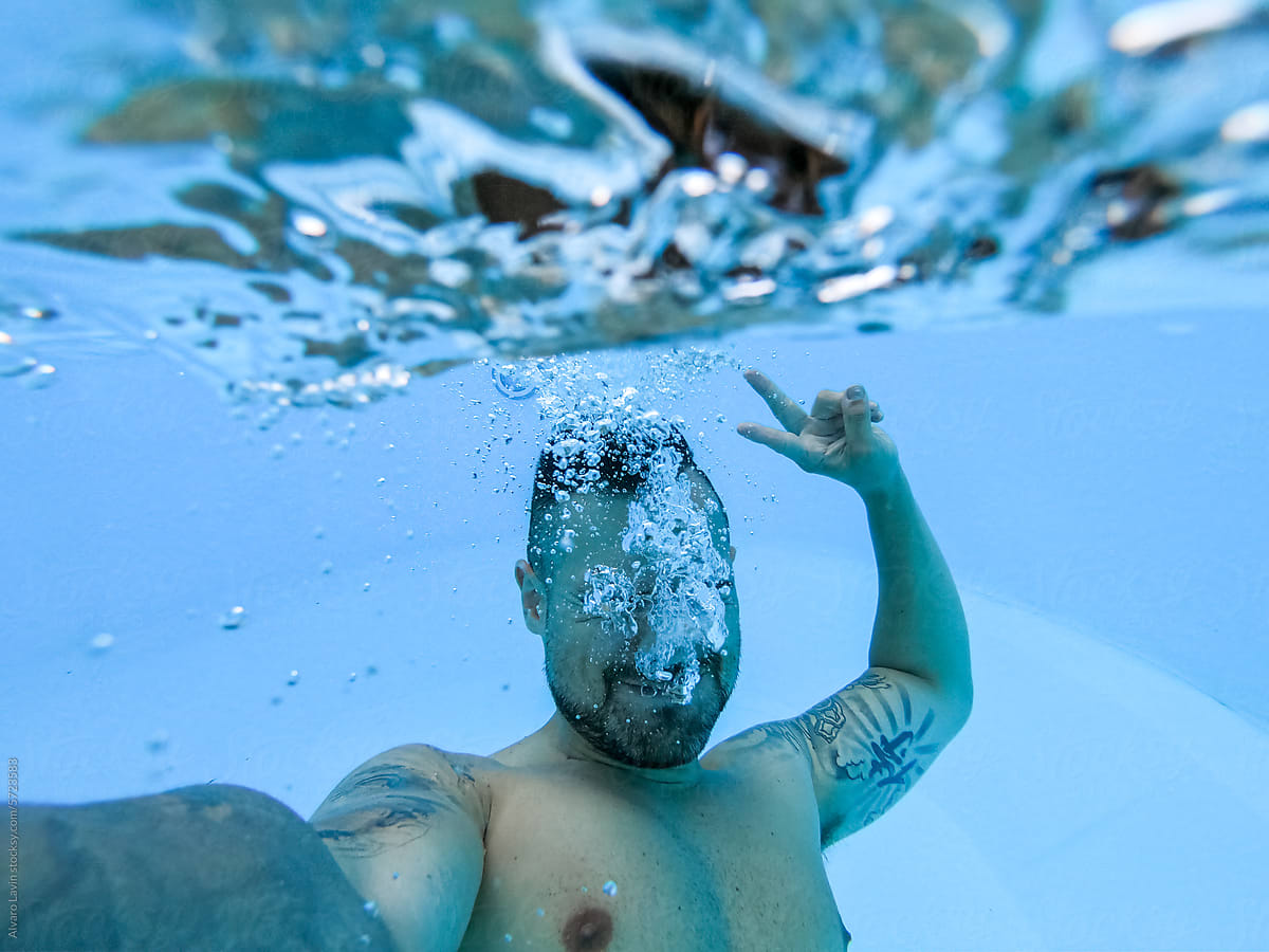 man taking a selfie in a swimming pool underwater