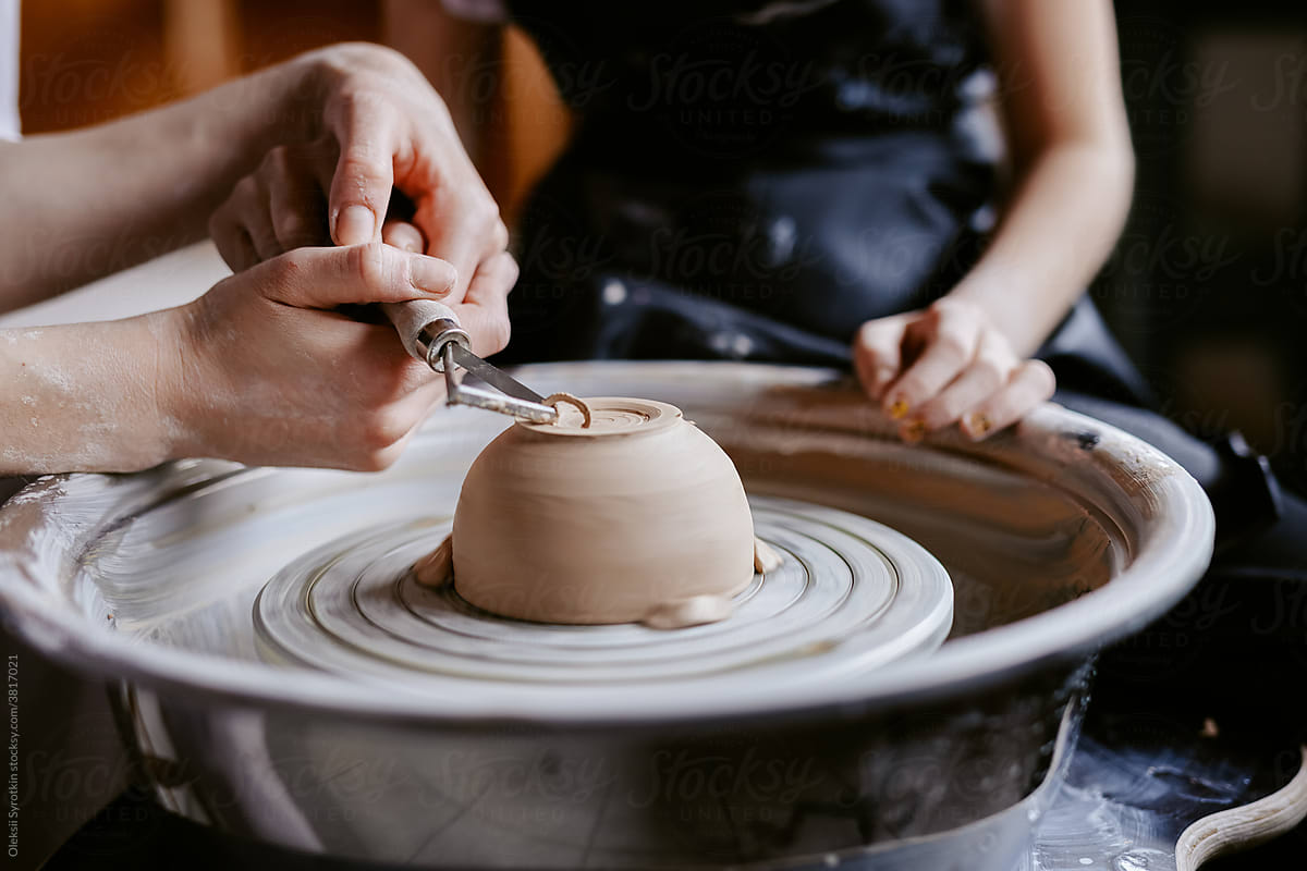 Ceramist using tools for work with pottery