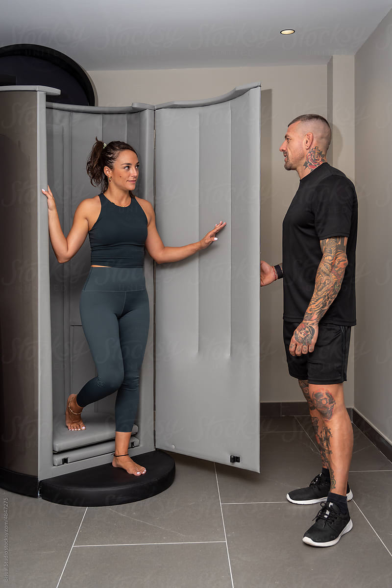 Athlete and coach near cryogenic chamber