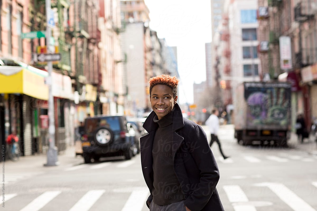 A Young Black Man Walking Across The Street By Bowery Image Group Inc Stocksy United