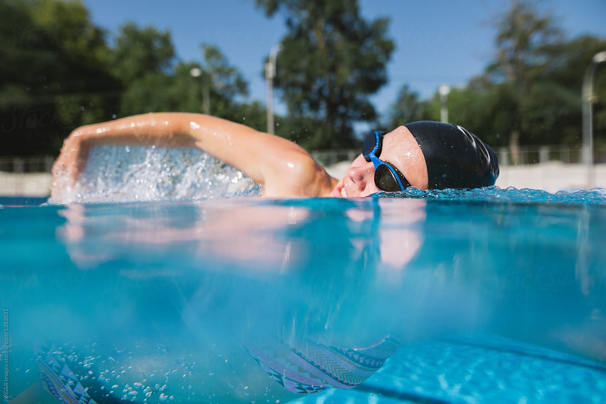 Portrait of woman swimming crawl in the pool