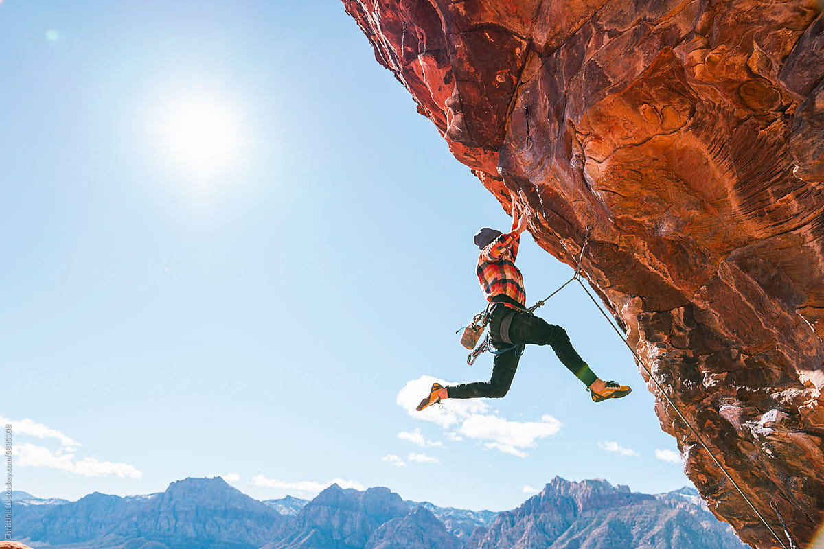 Rock climber reaching up