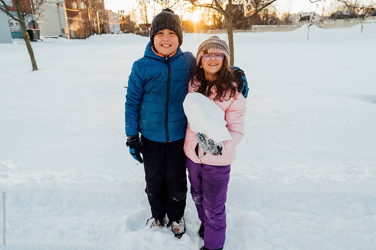 Two children posed for a snowy portrait.