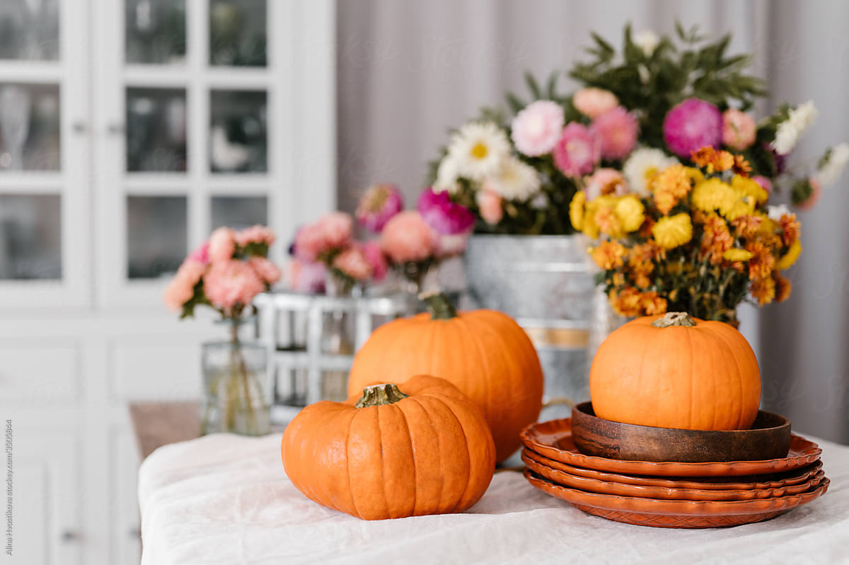 Flowers and pumpkins in dining room