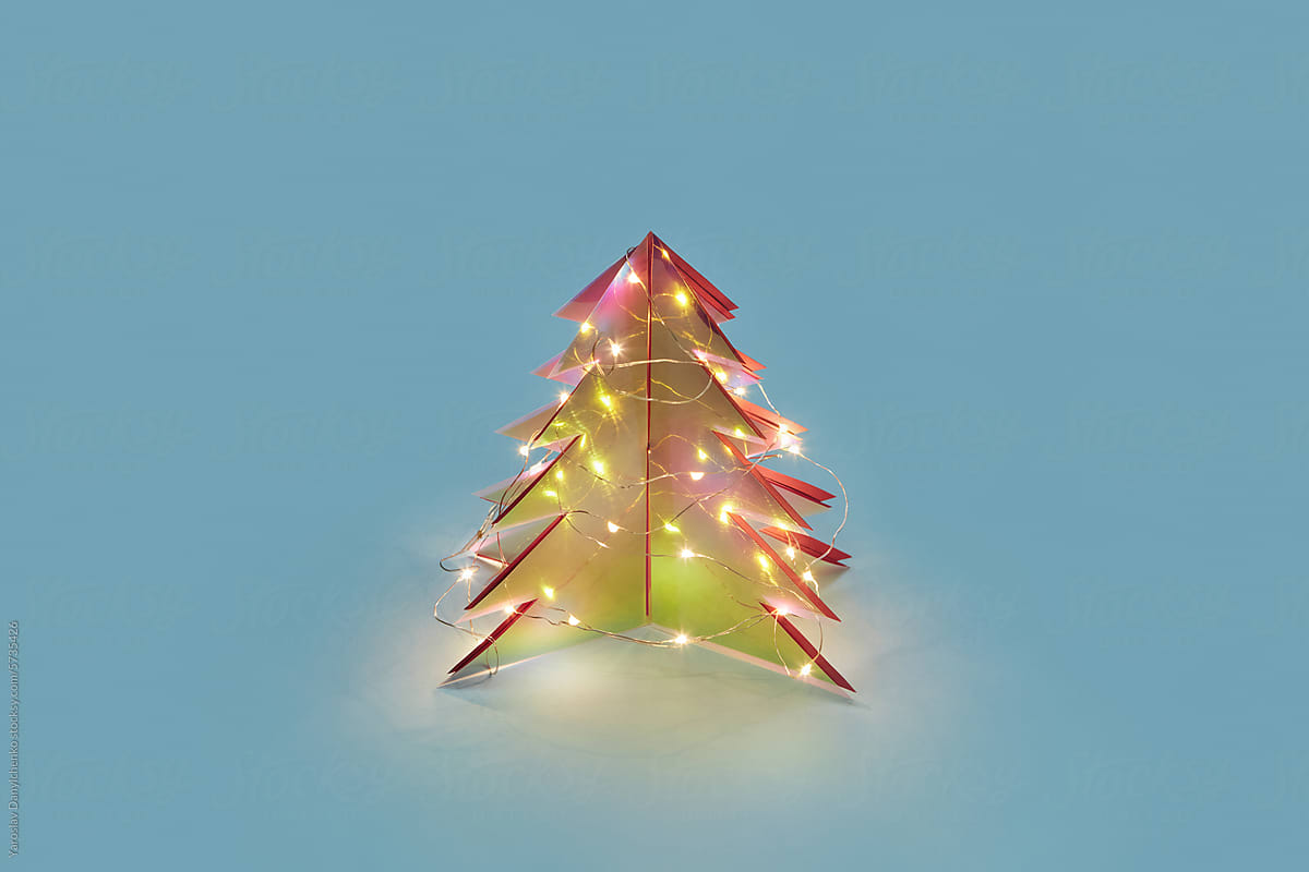 Handmade miniature Christmas tree adorned in garland lights