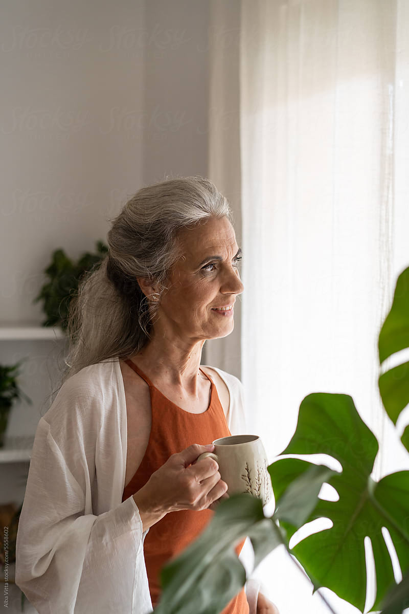 Happy retired woman with coffee cup portrait