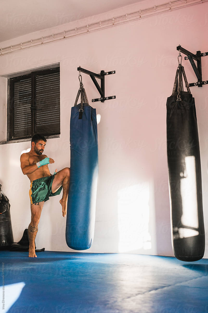 Male Kickboxing Athlete During A Bag-work Session