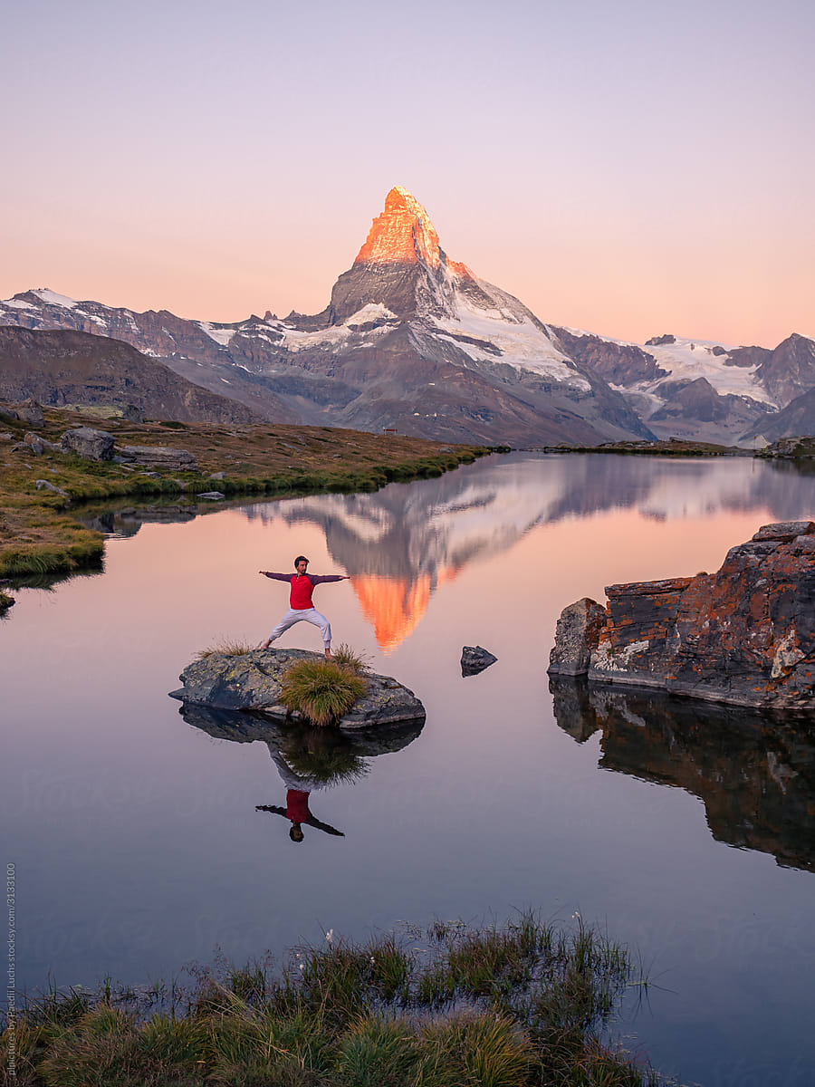 Yoga Warrior II on alpine lake