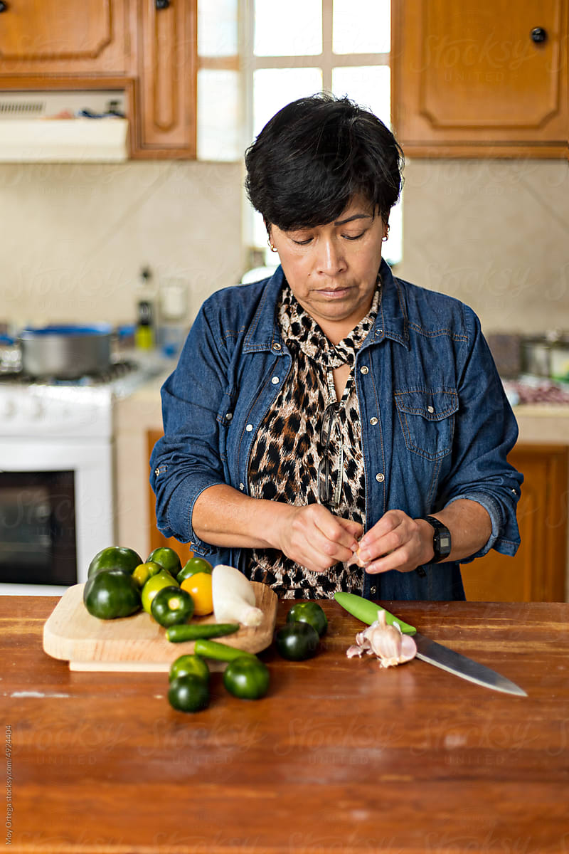 Woman chopping fresh vegetables with a knife