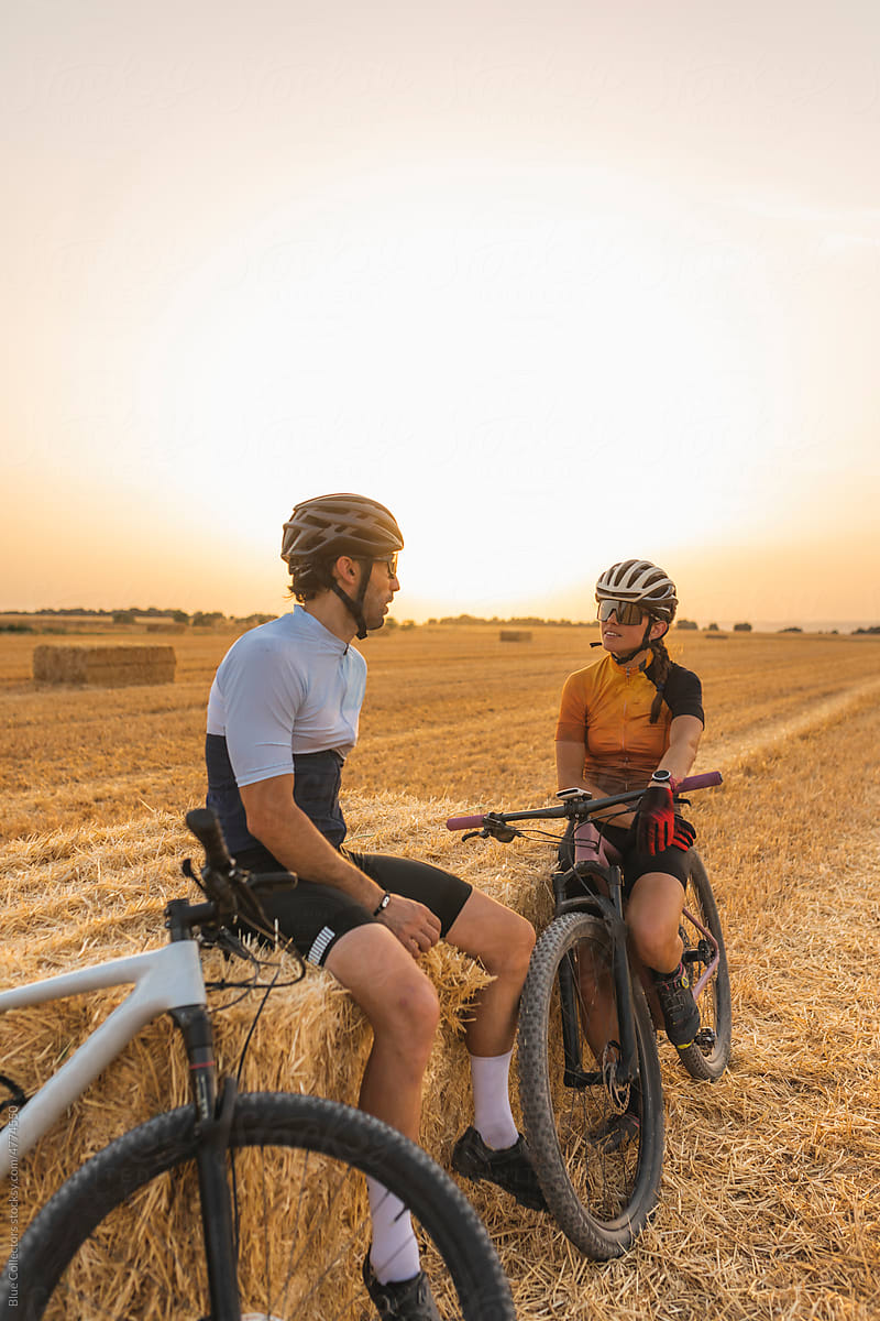 Two mountain bikers on wheat fields
