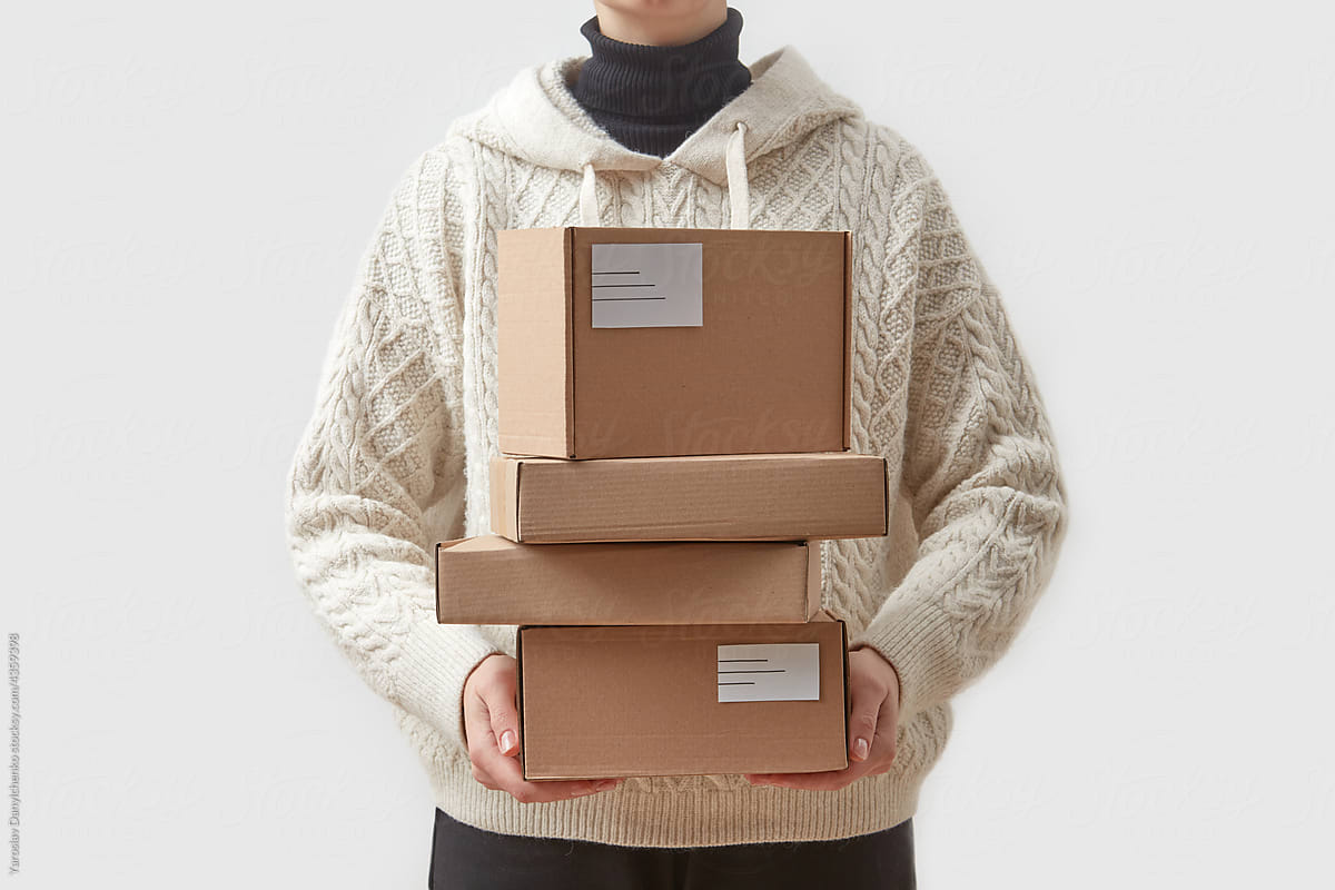 Female person holding cardboard delivery boxes