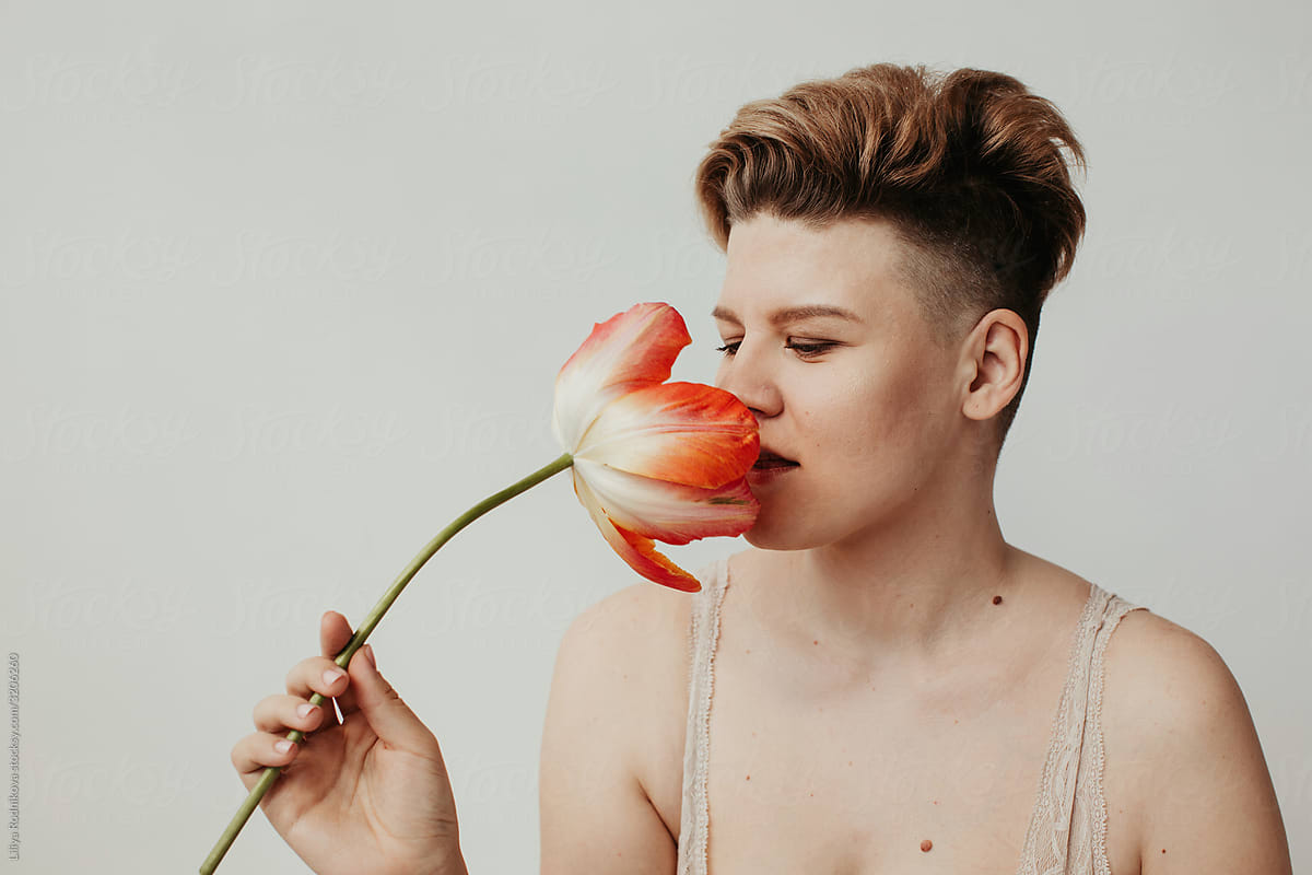 Woman with short haircut smelling tulip