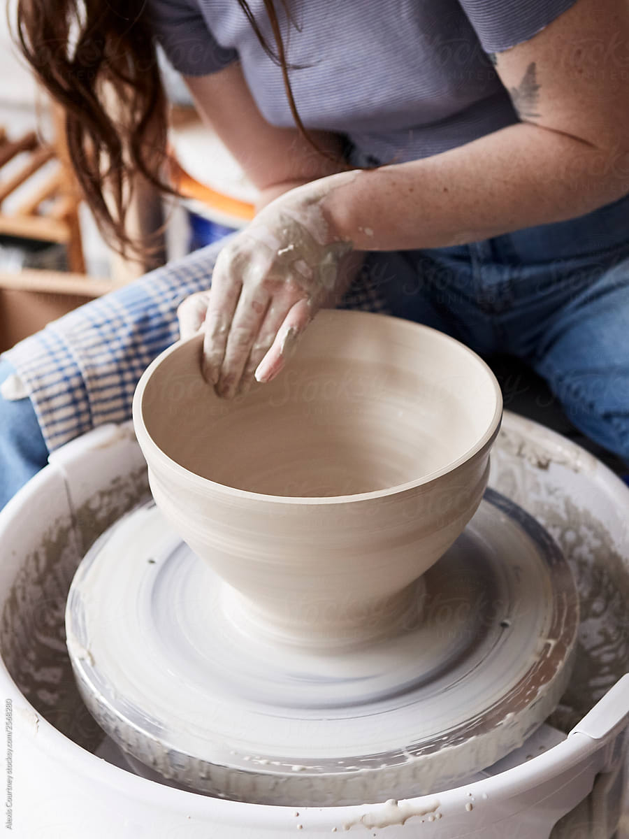 Potter throwing a large bowl on the potters wheel