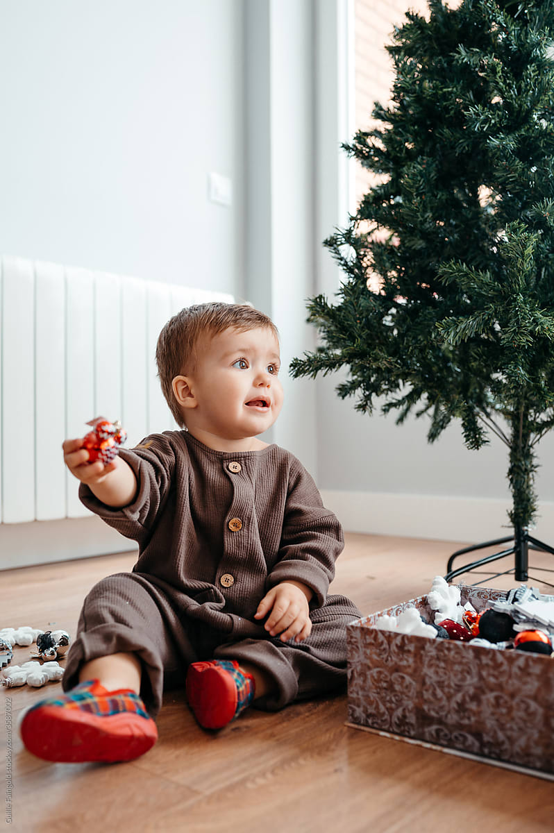 Boy playing with Christmas ornaments