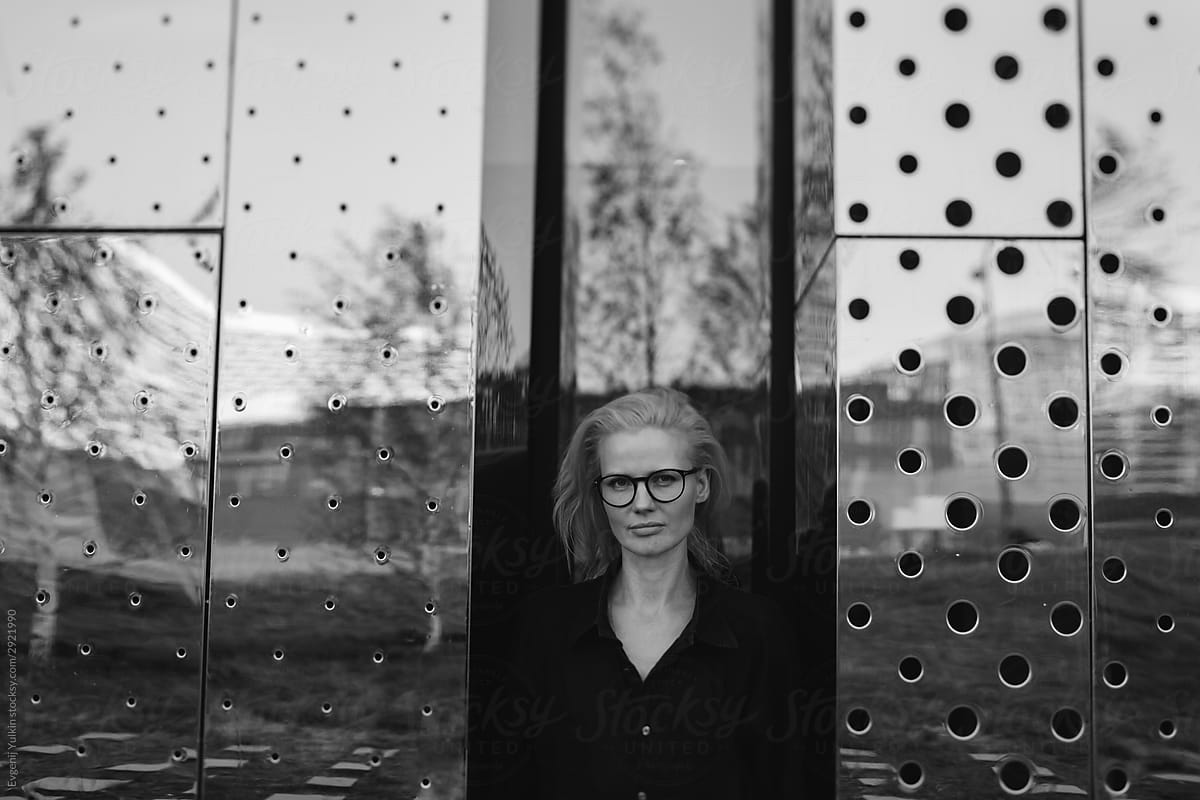 Woman among  steel mirror panels