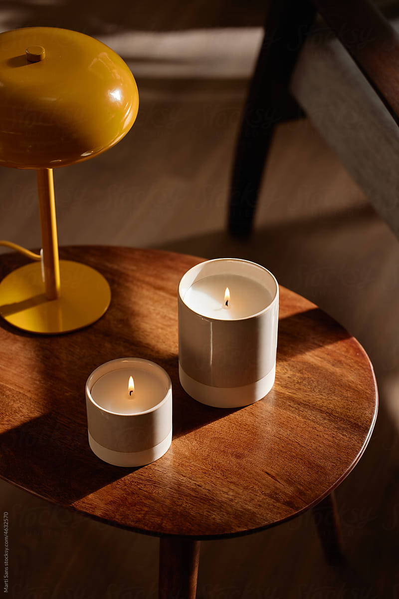 Aromatic candles near yellow lamp
