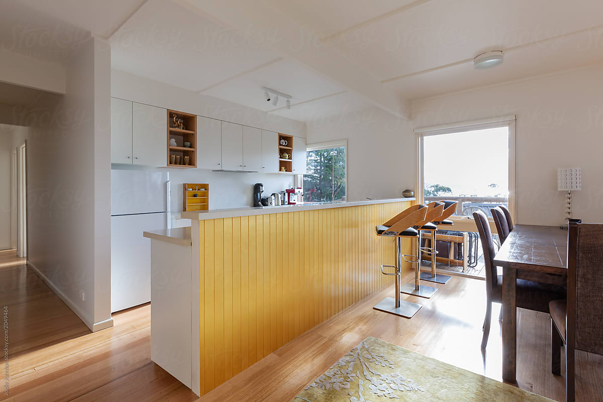 Beach house kitchen with yellow panelling