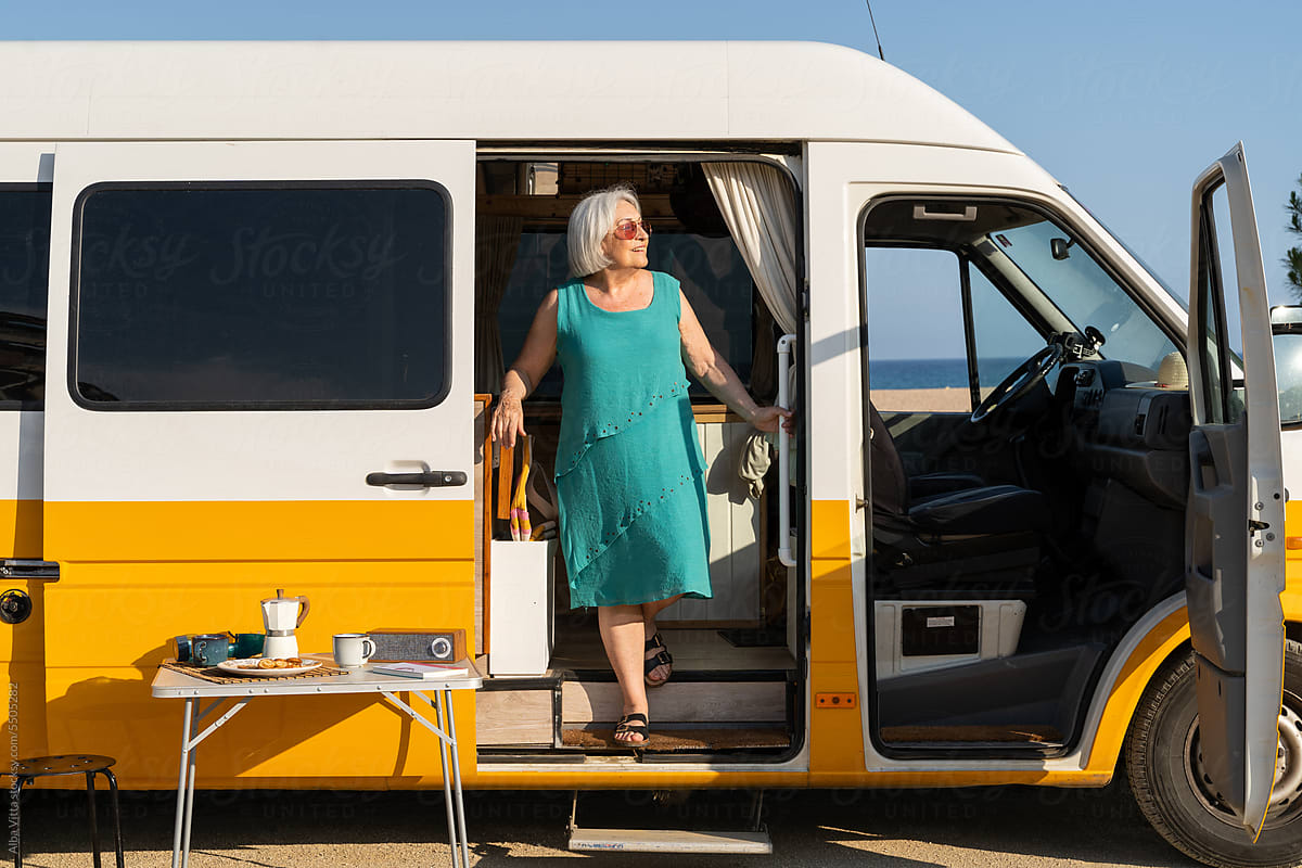 Happy retired woman in camper van