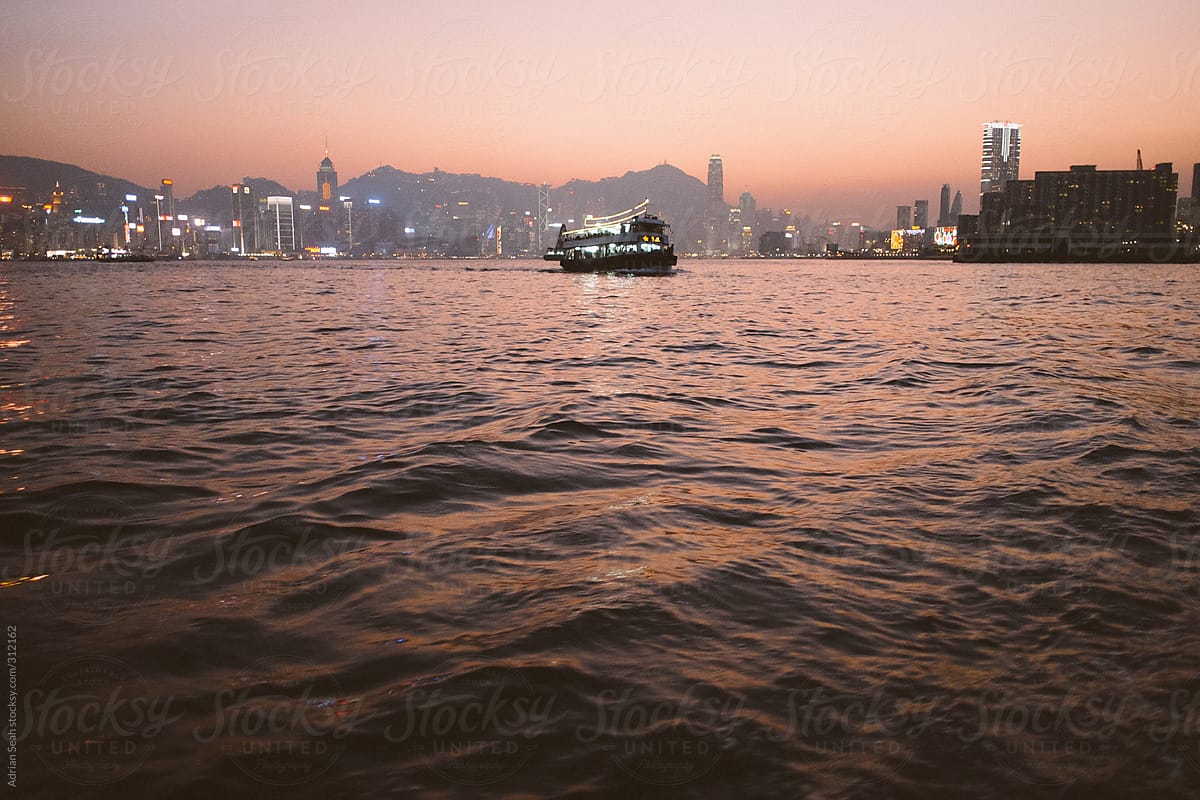 Ferry Crosses Victoria Harbour in Hong Kong at Dusk