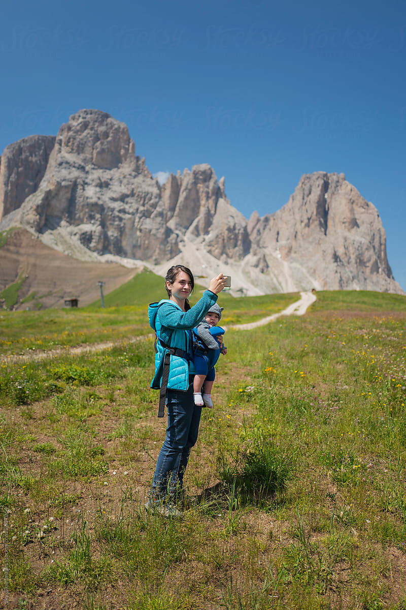 Mother carrying a baby on the Dolomites