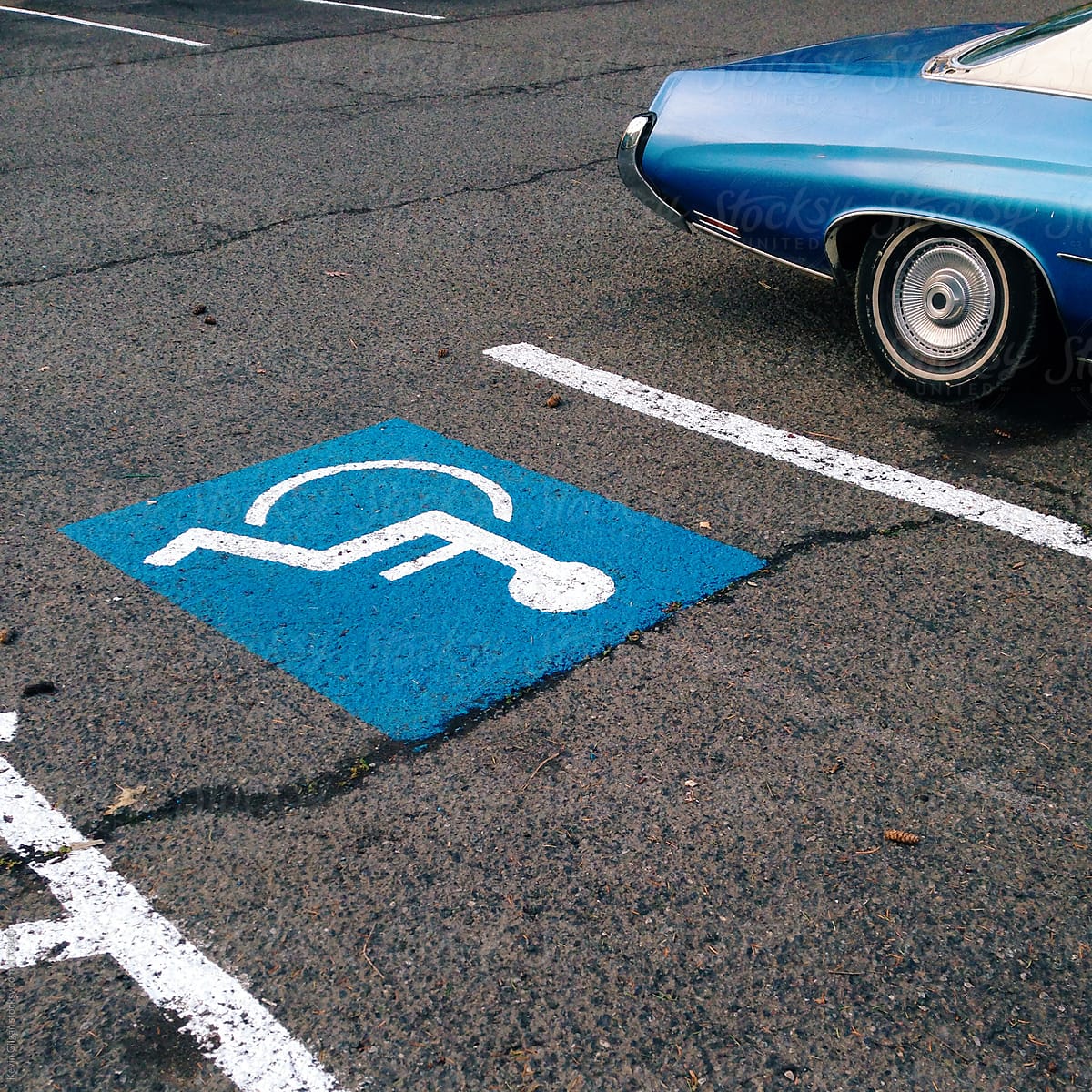 Blue Car Next to Handicap Parking Spot