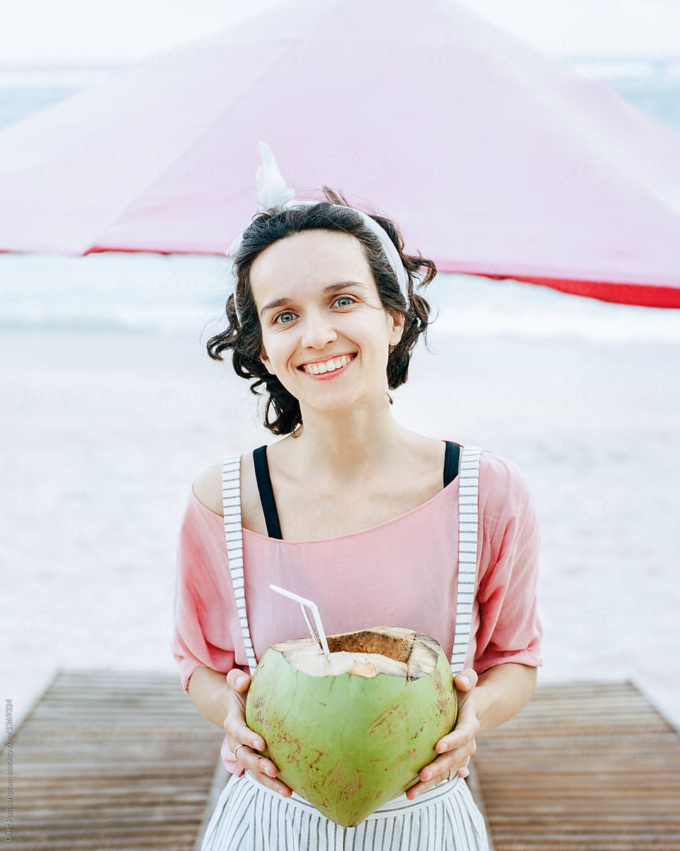 Cheerful woman with coconut