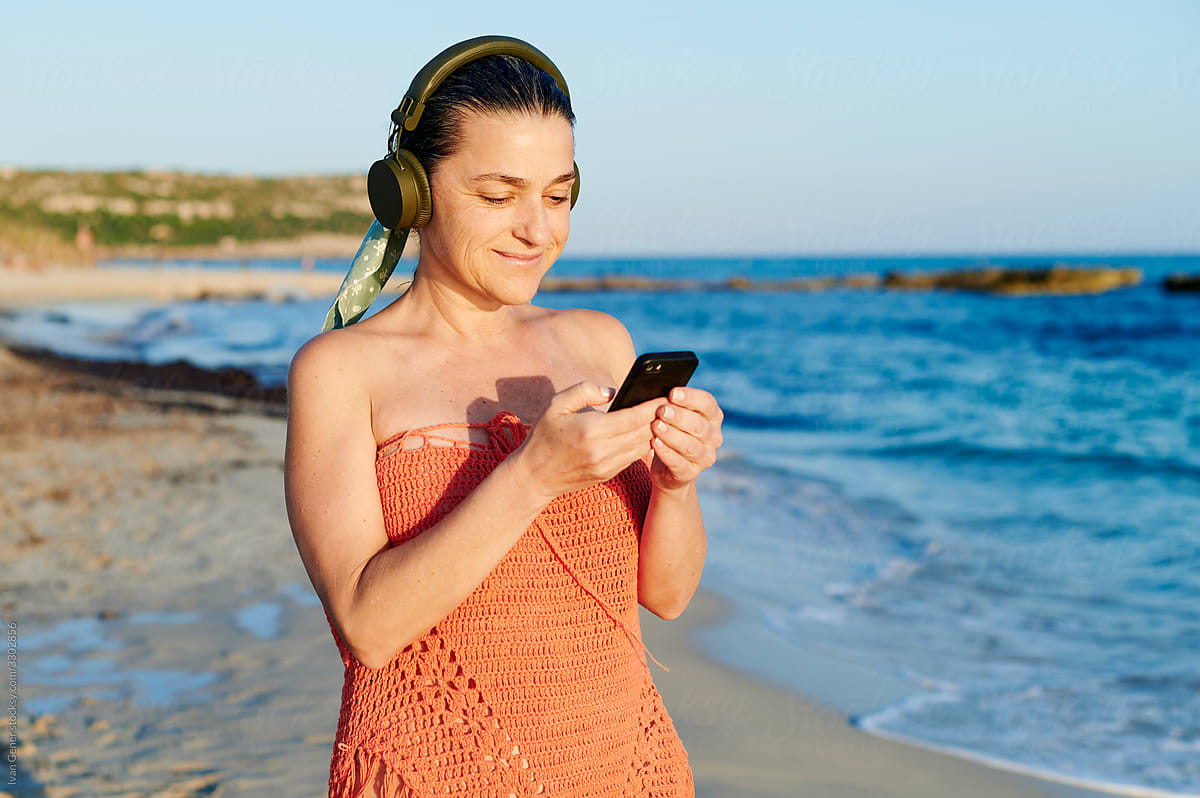 Woman listening to music at the beach