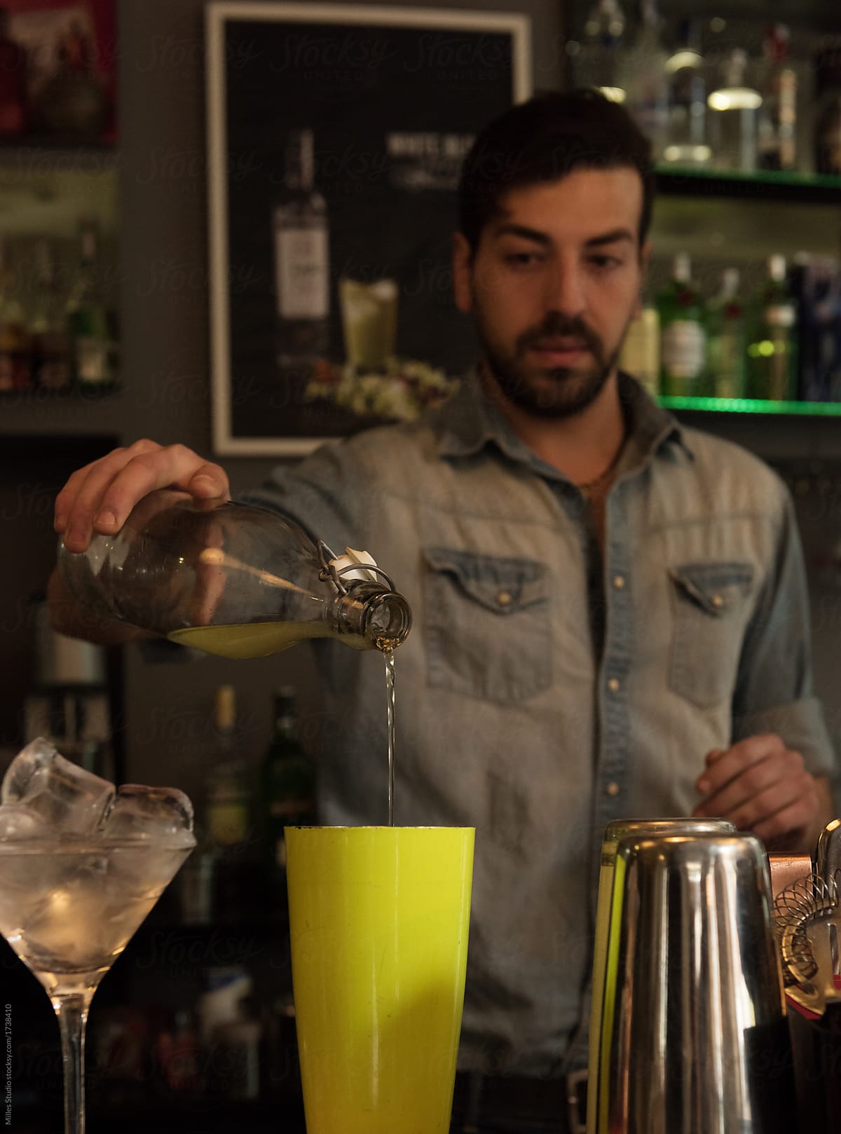 Concentrated bartender creating cocktail