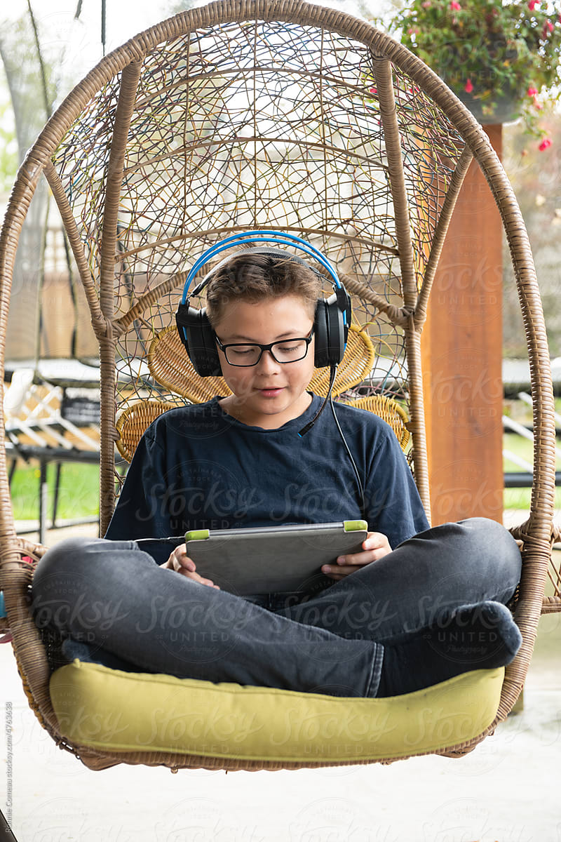 Tween Boy Video Gaming on Tablet Outdoors