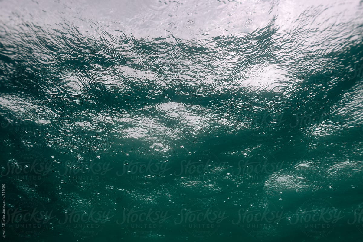 Raining on the ocean surface seen from underwater