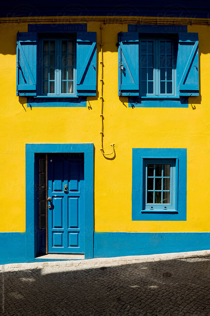 Yellow house with blue windows