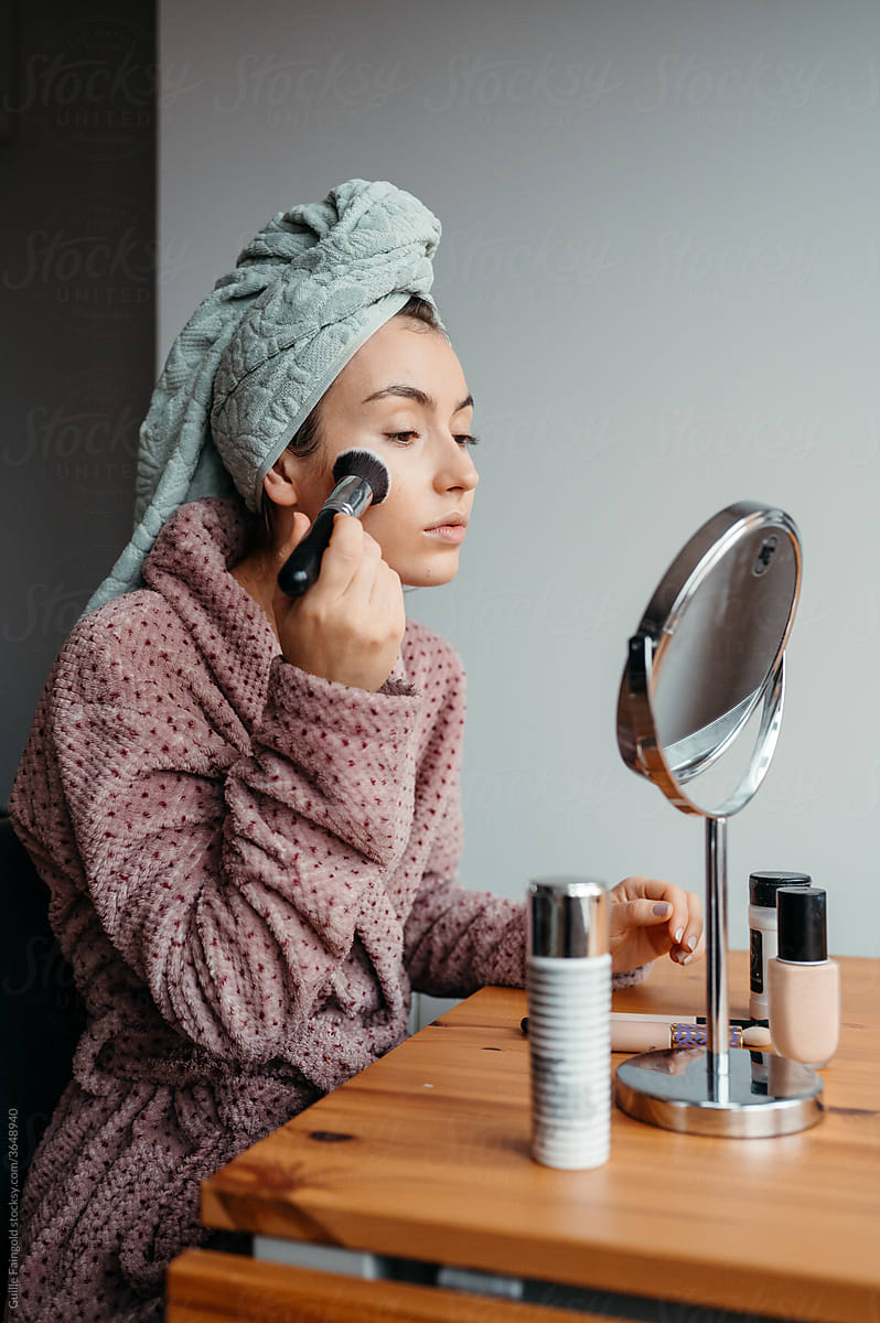 Relaxed woman after doing makeup in morning