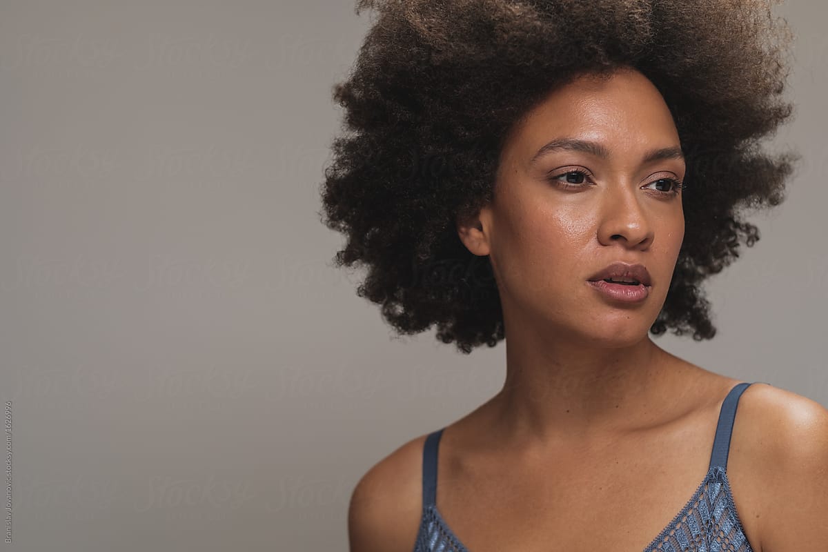 View Portrait Of Beautiful Mixed Race Woman With Afro Hairstyle By