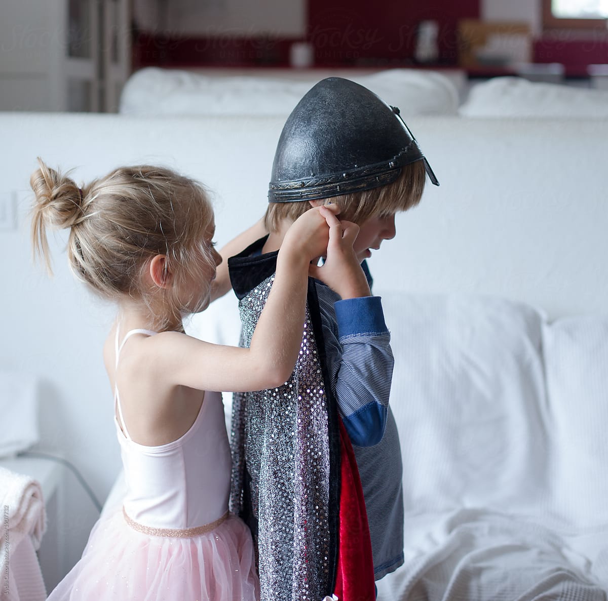 Two children playing dress up as warrior and dancer
