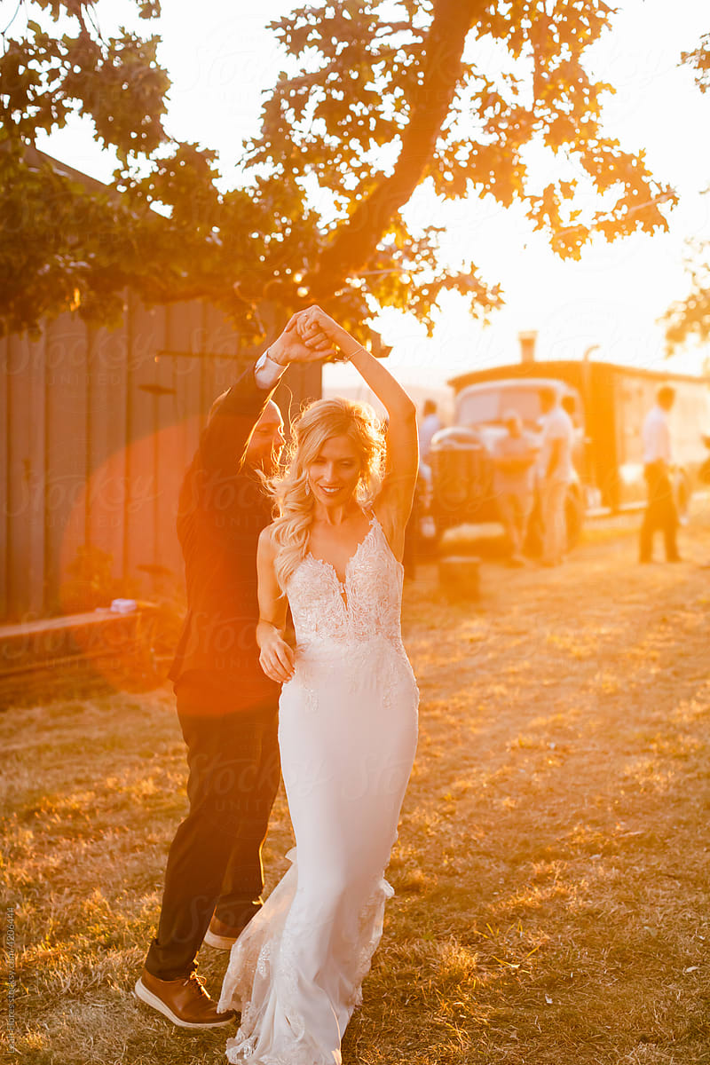Bride and Groom Dancing at Sunset