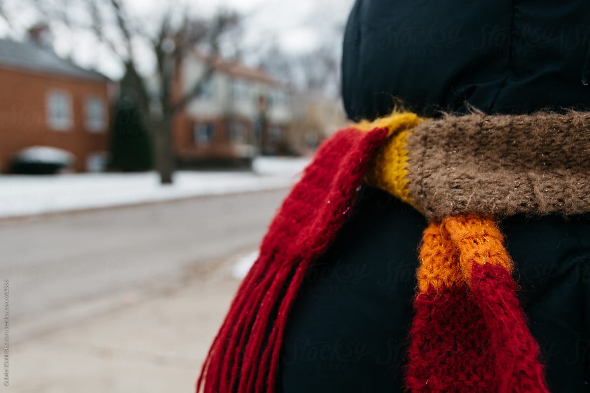 Child bundled up on a winter day with a colorful scarf