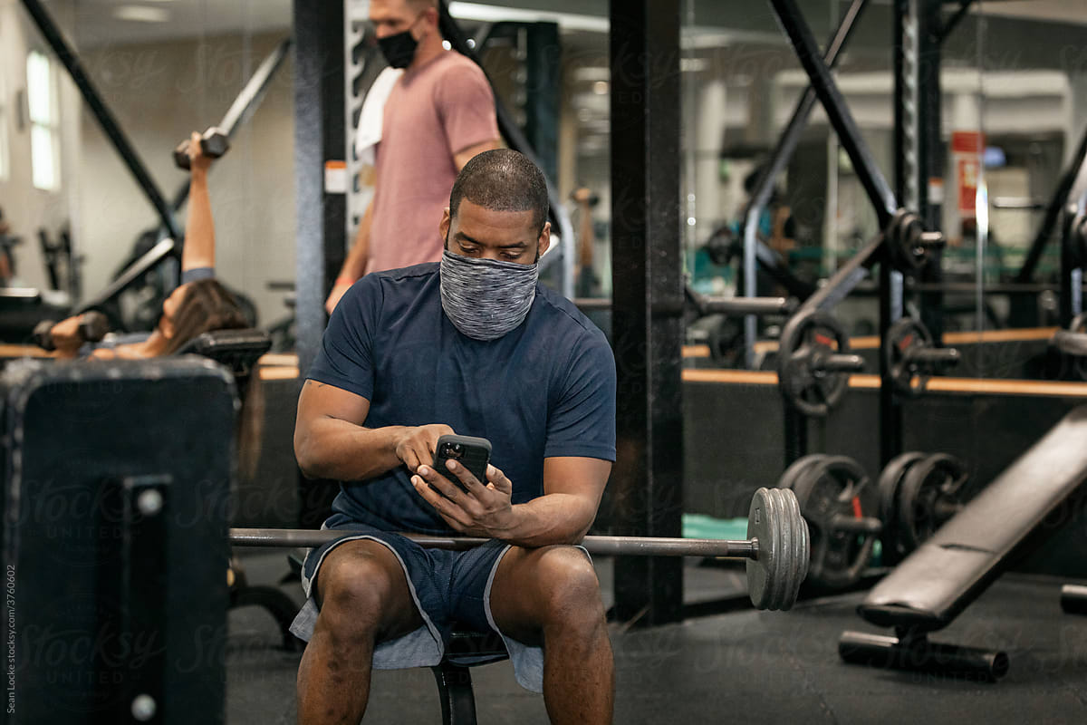 Gym: African American Man Uses App On Smart Phone
