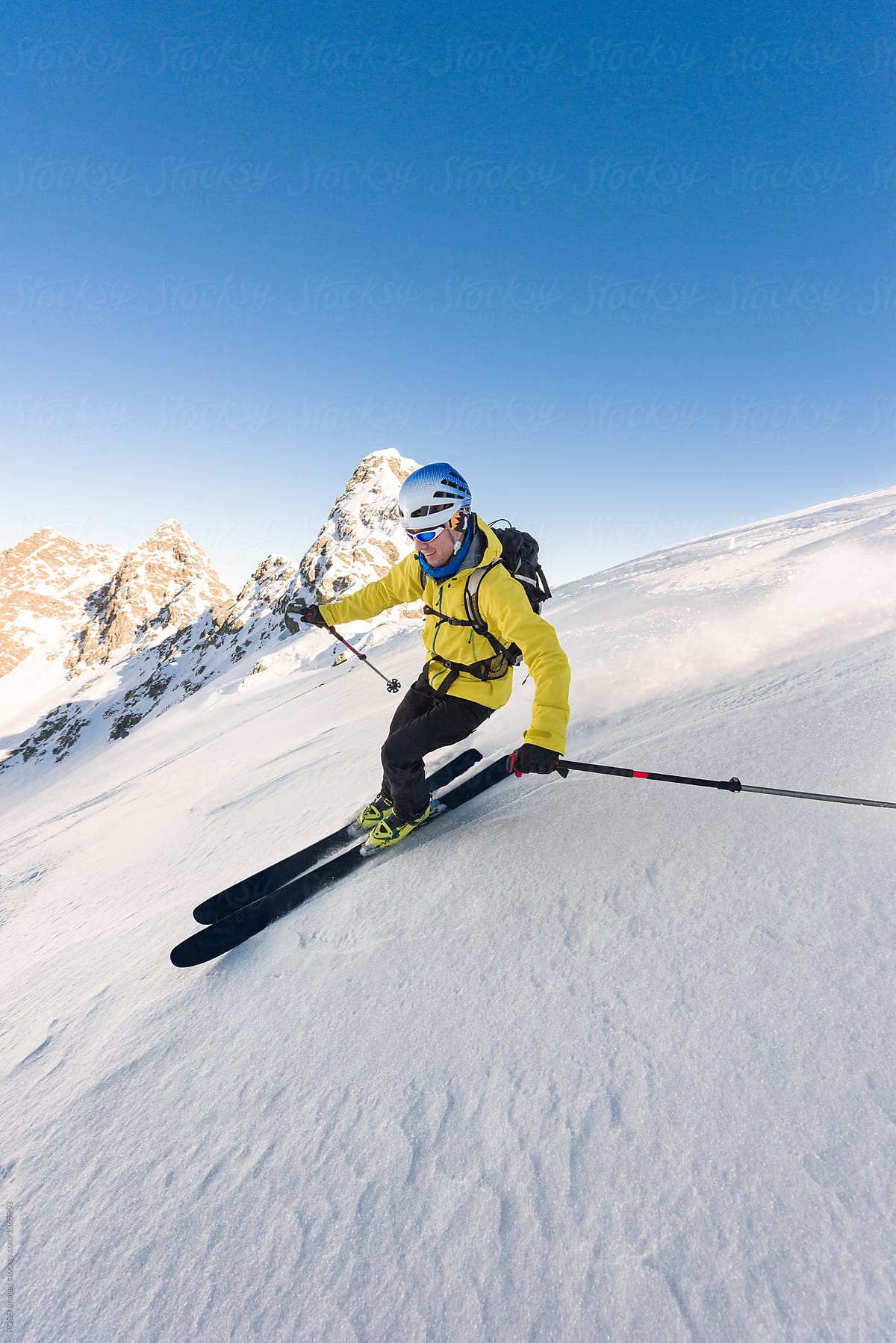 Man skiing downhill steep slope with high speed