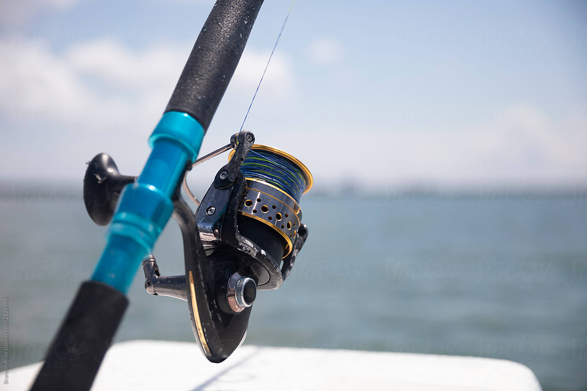 Closeup Of A Fishing Pole Rod And Reel by Stocksy Contributor