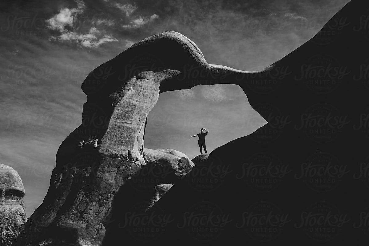 Black and white photo of dramatic rock arch