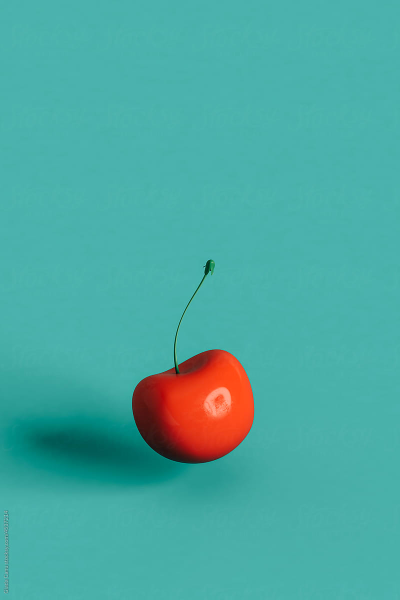 red cherries on a blue background with copy space