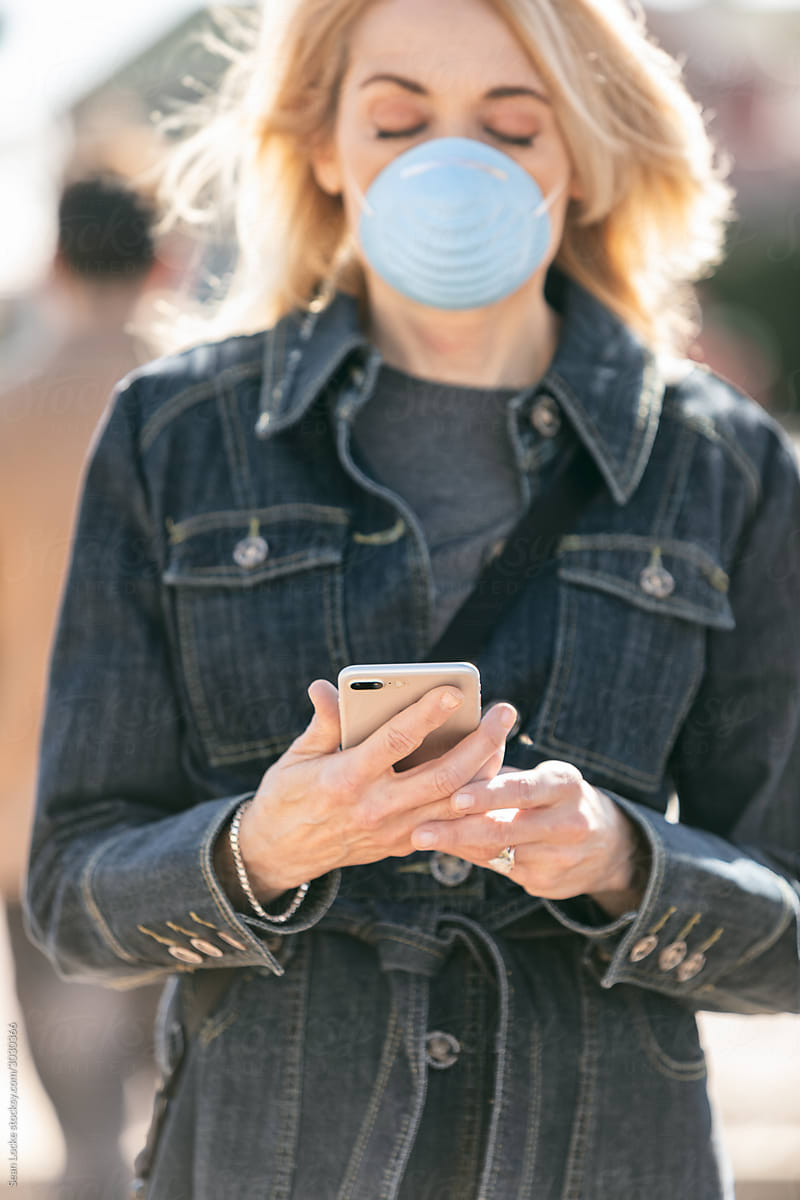 Virus: Woman Uses Cell Phone While Wearing Medical Mask
