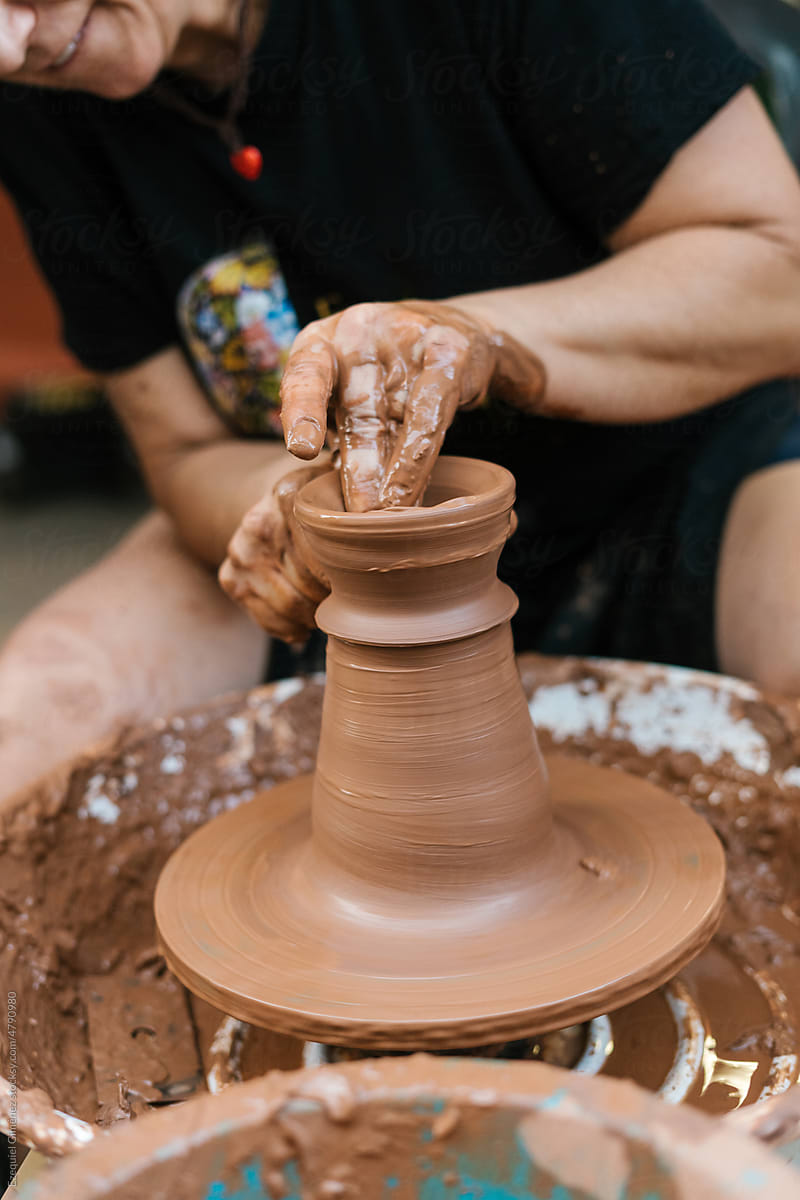 Anonymous person making clay vase