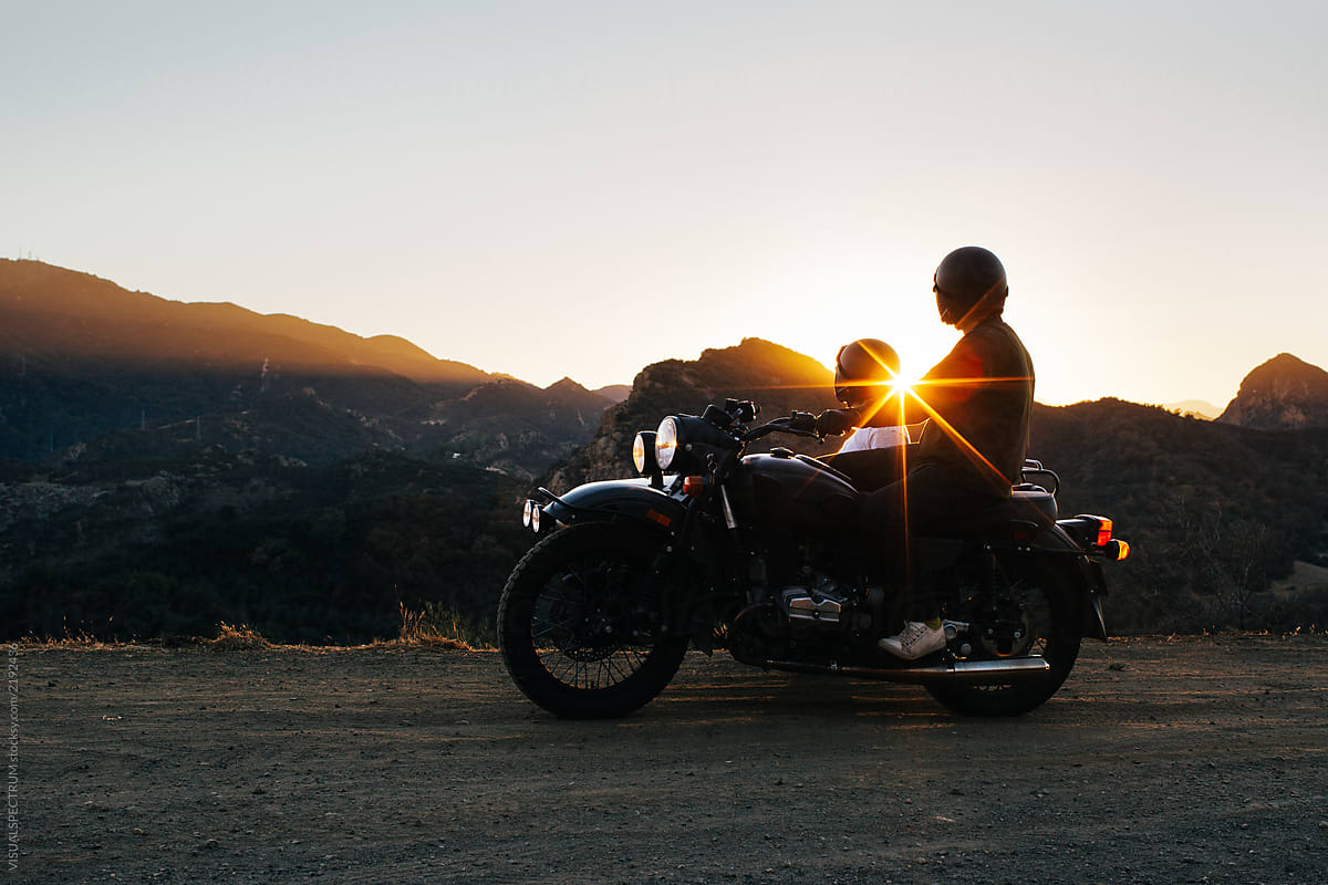 Young Anonymous Couple Watching California Sunset on Vintage Motorbike