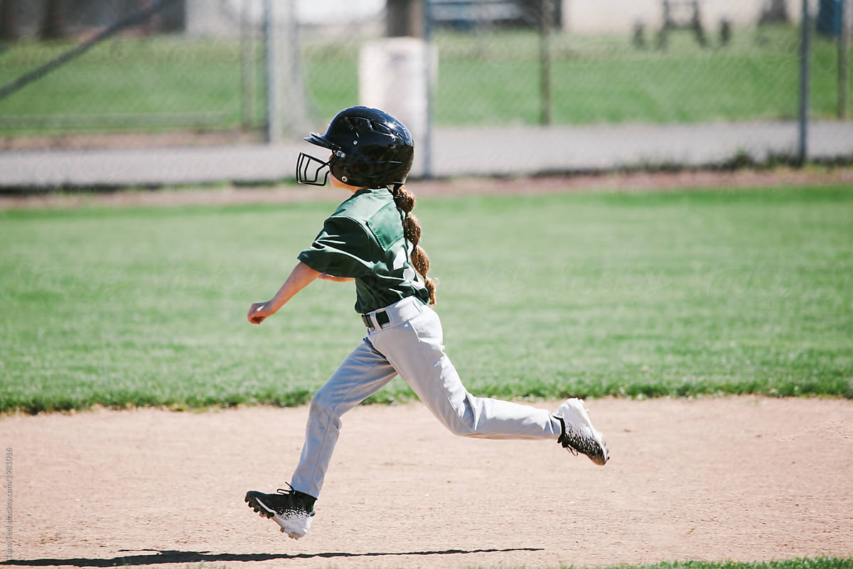 A Young Girl In Retro Baseball Jersey Swinging Baseball Bat. by Stocksy  Contributor Tana Teel - Stocksy