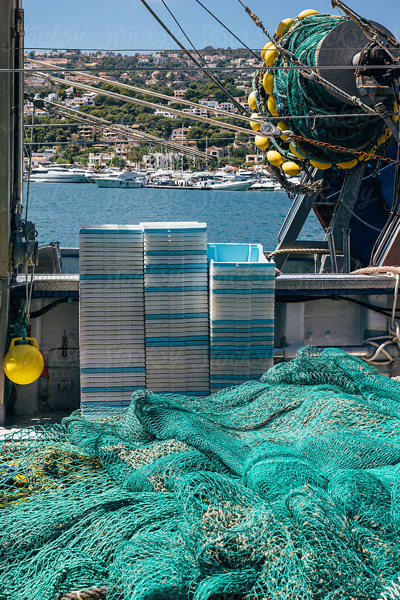 Pile of various fishing nets and containers on the boat