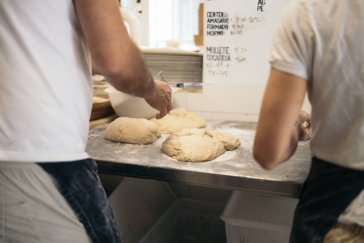 Bread Makers Working With Dough In Bakehouse