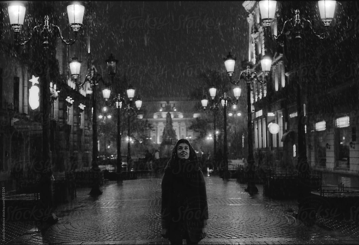 Girl looking to the snow in Saint Petersburg's night
