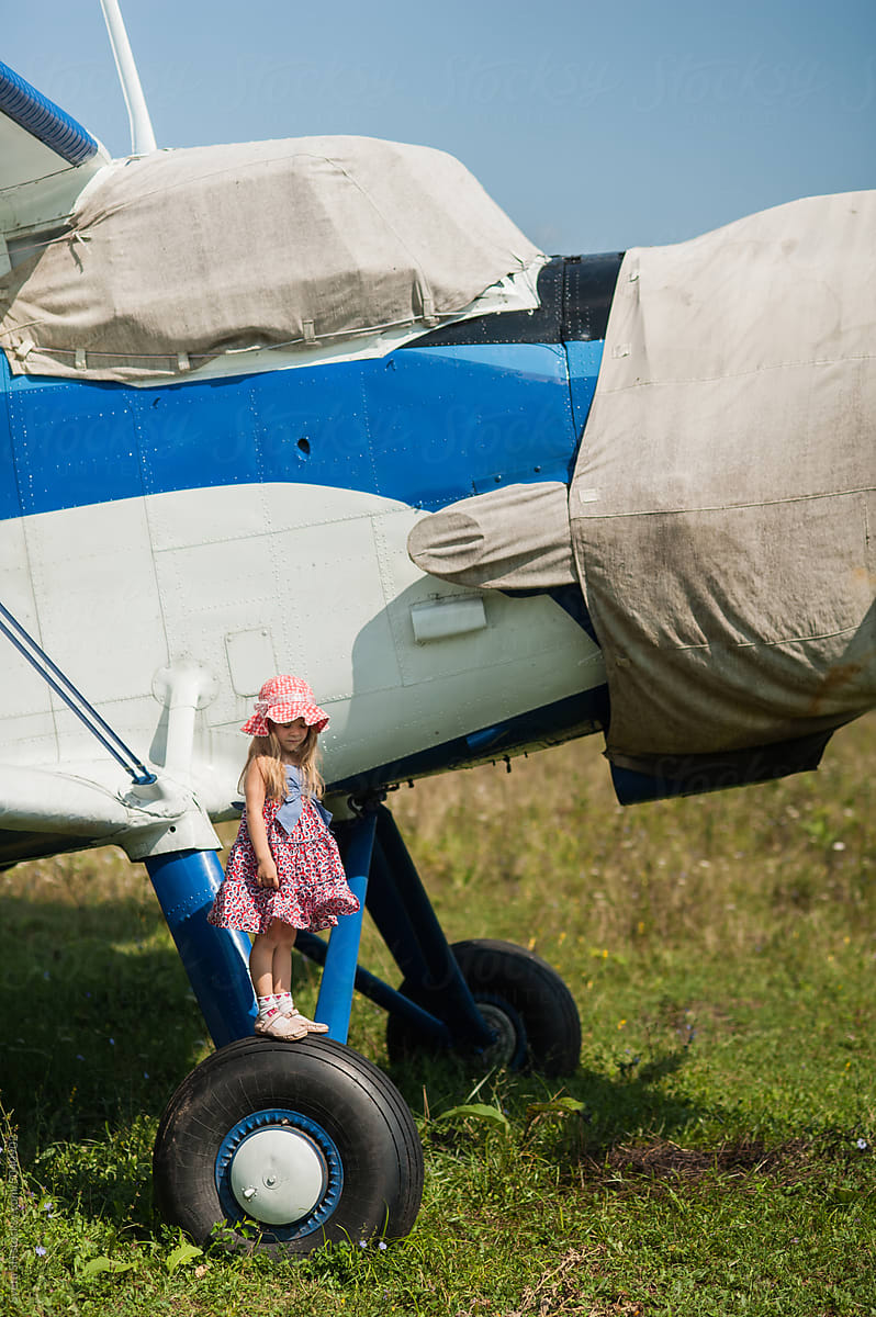 Little girl and biplane