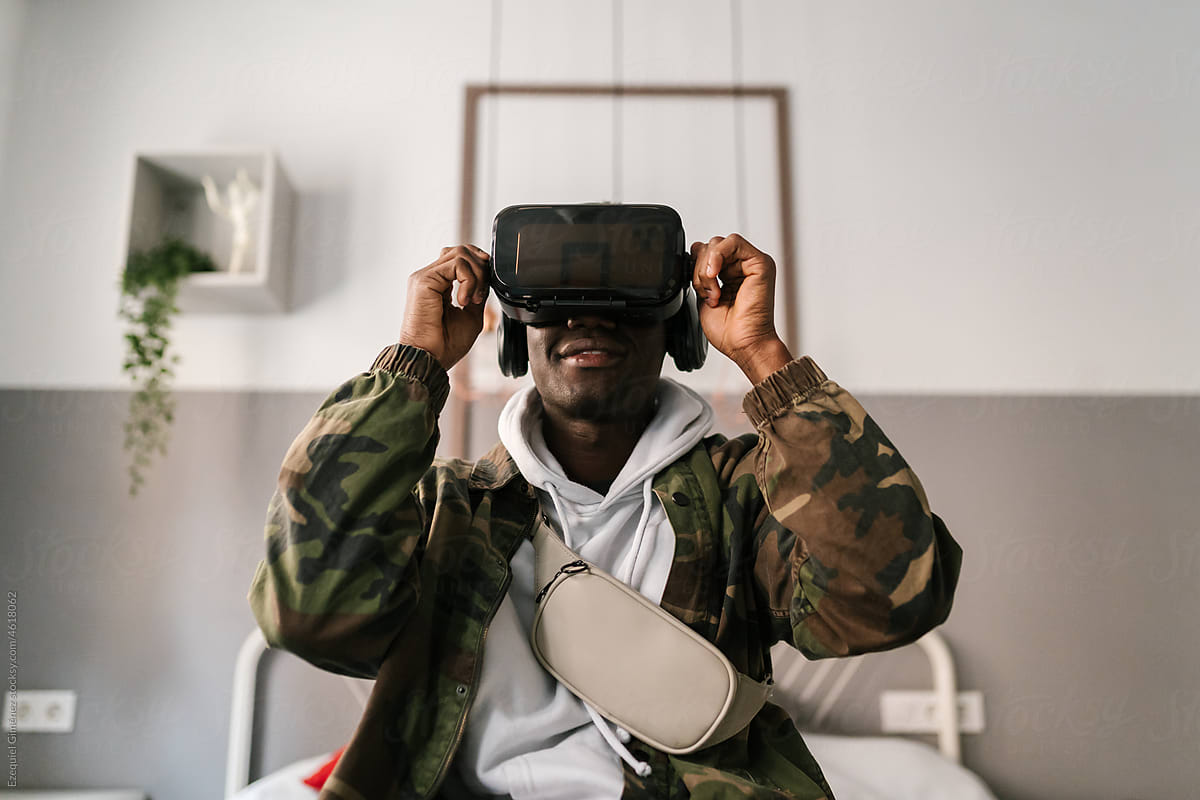 Black male adjusting VR headset and watching video